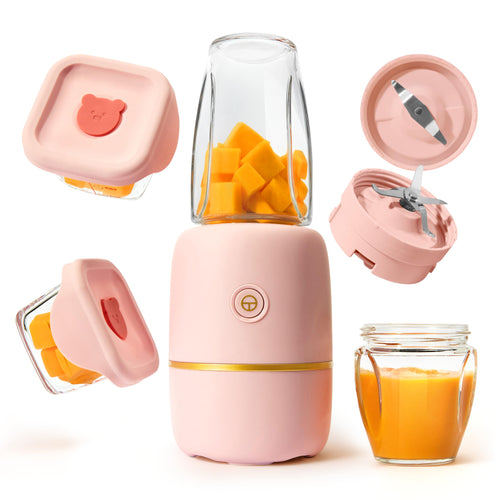 Pink portable blender with ingredients and a glass of juice on a white background